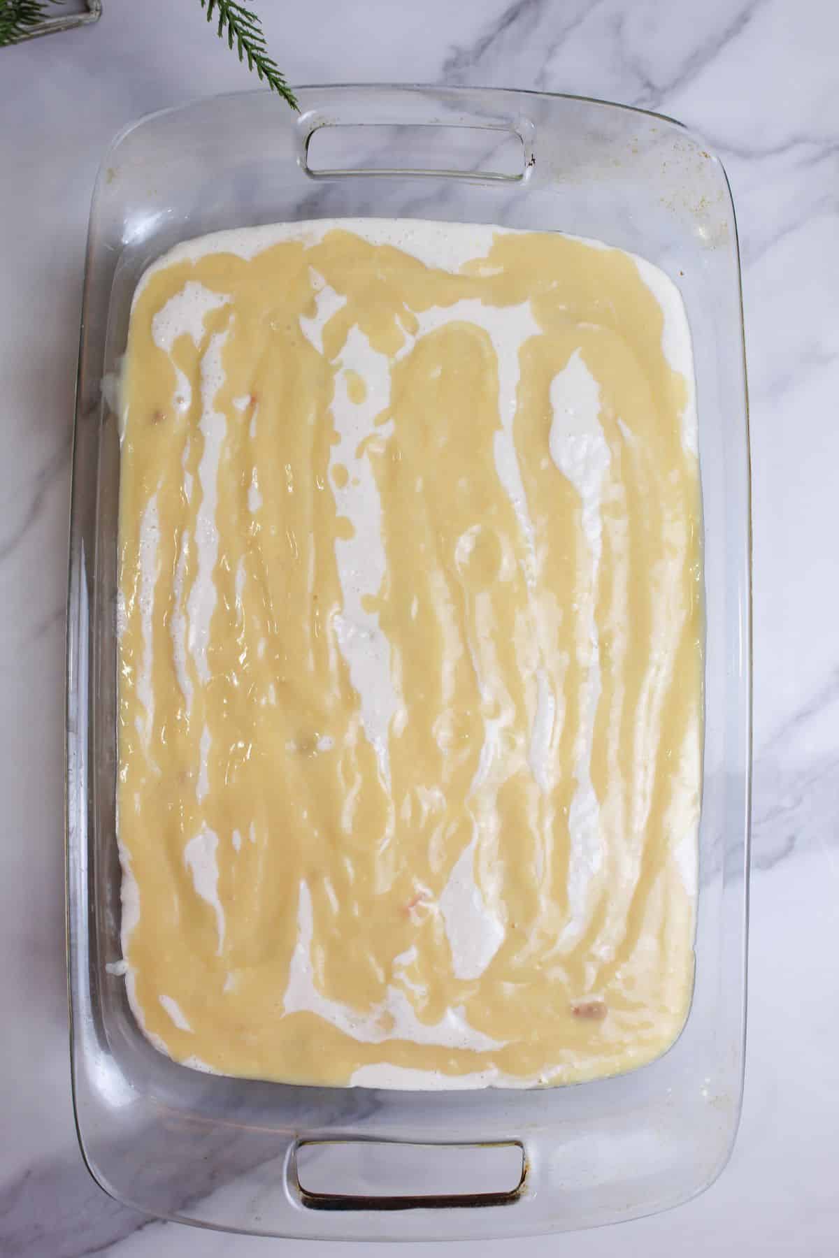 chicken cobbler in a glass baking dish ready for the oven.