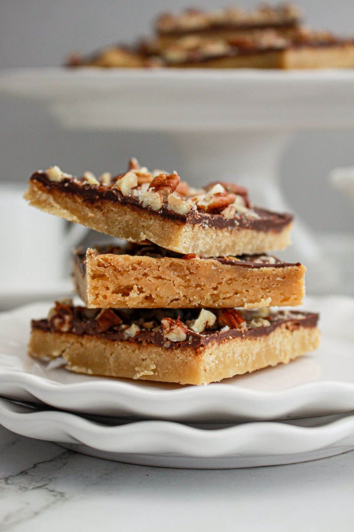 three pieces of toffee squares stacked on top of each other.