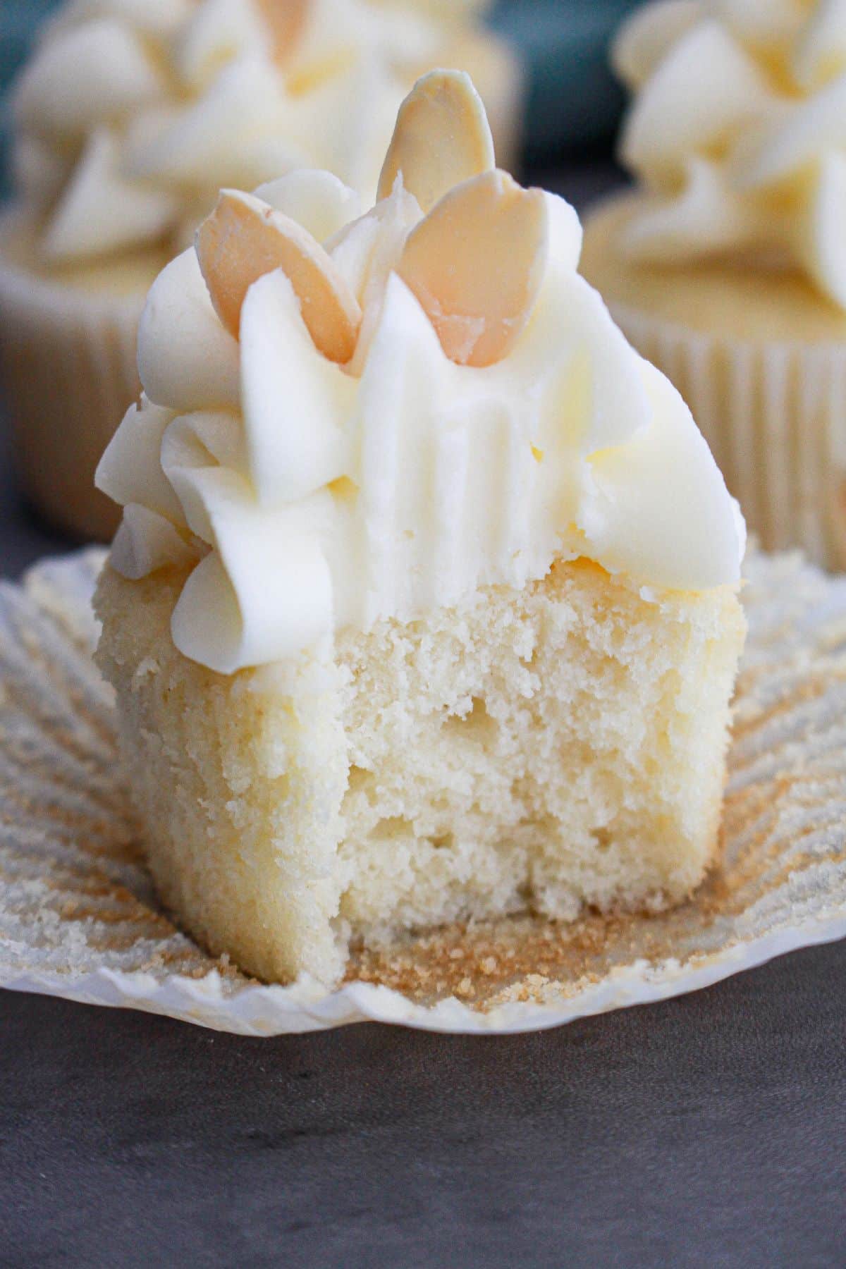 almond cupcake with a bite missing.