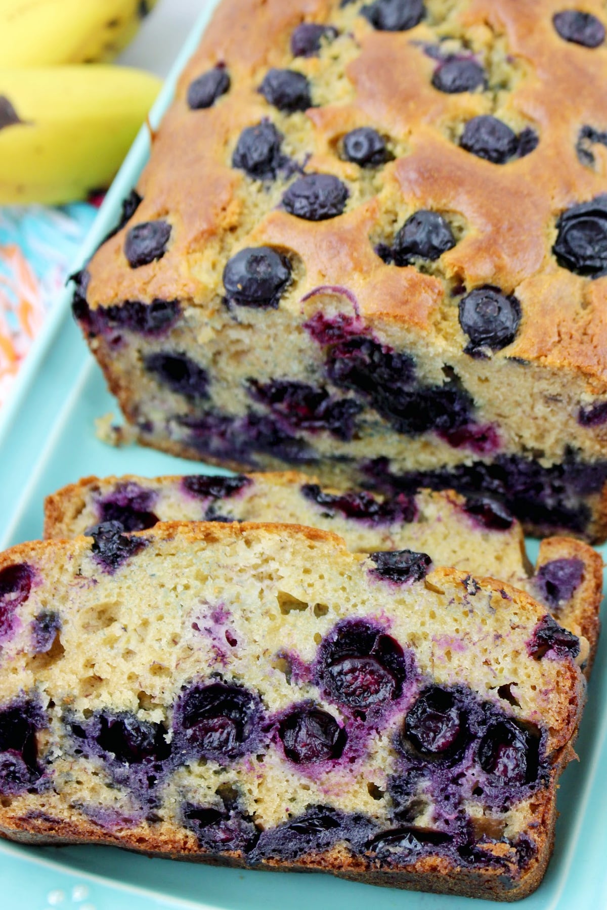 two slices of blueberry bread on a plate.