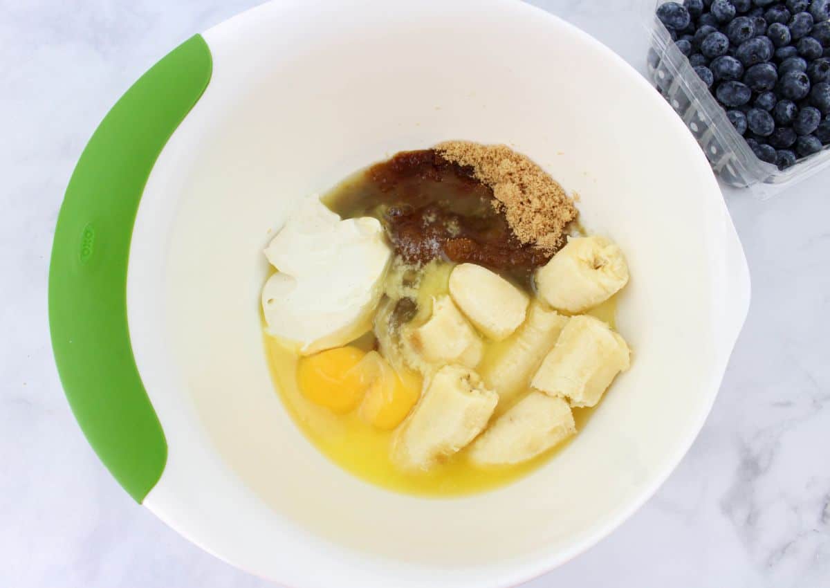 wet ingredients being mixed in a large mixing bowl.