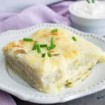 slice of sour cream and chive scalloped potatoes on a plate.