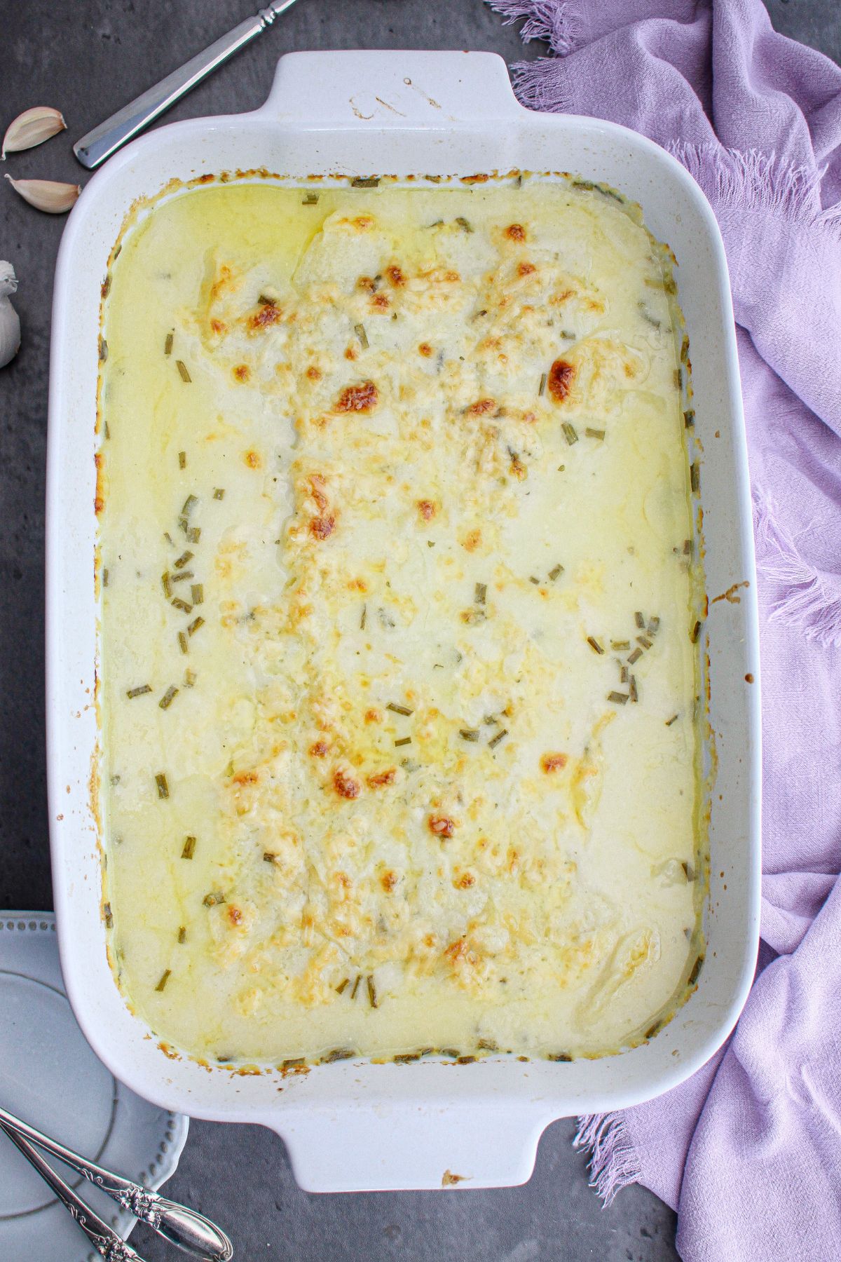 scalloped potatoes baking in a casserole dish.