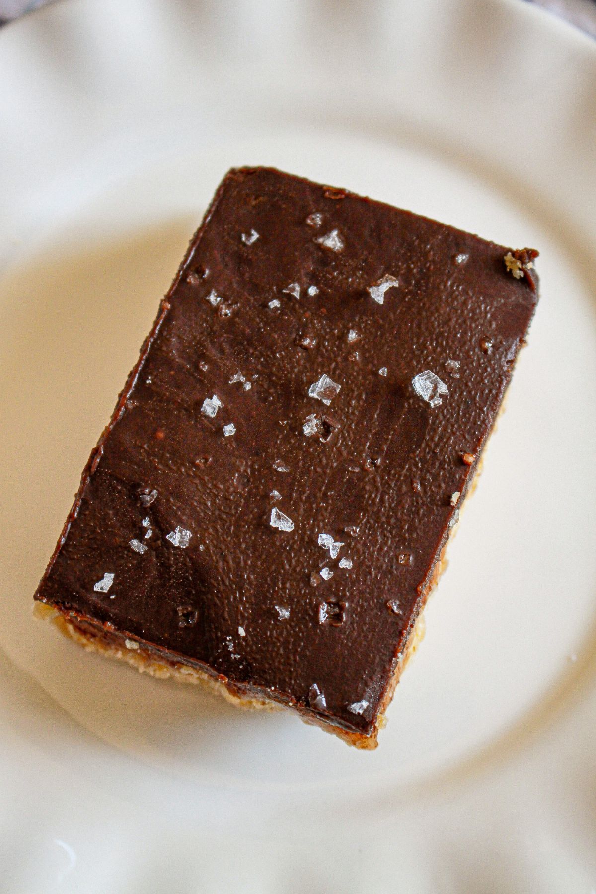 slice of chocolate caramel bar on a plate.
