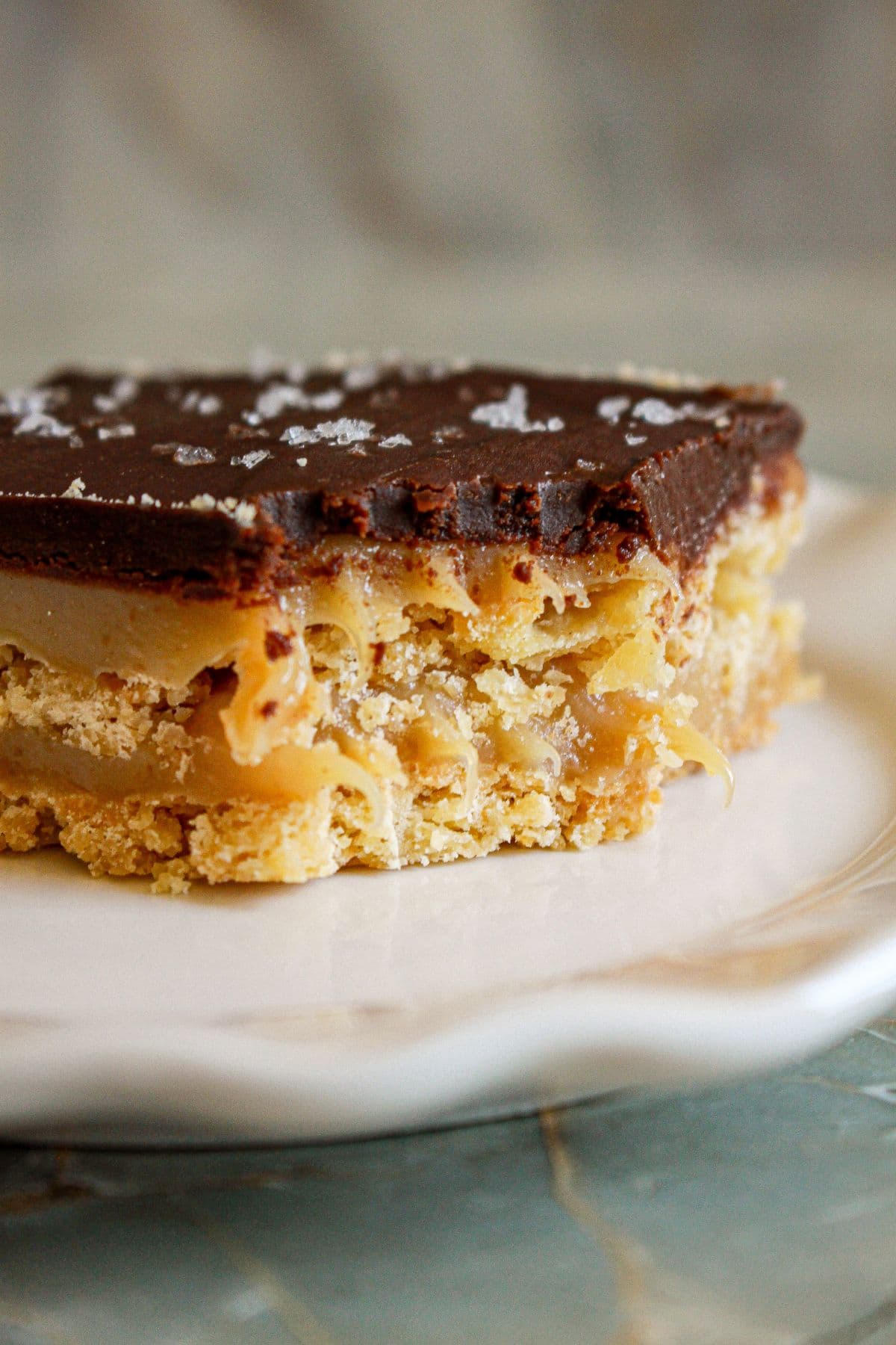 square of chocolate caramel bar on a plate.