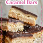 four chocolate caramel bars on a plate.