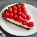 slice of chocolate raspberry tart on a plate.