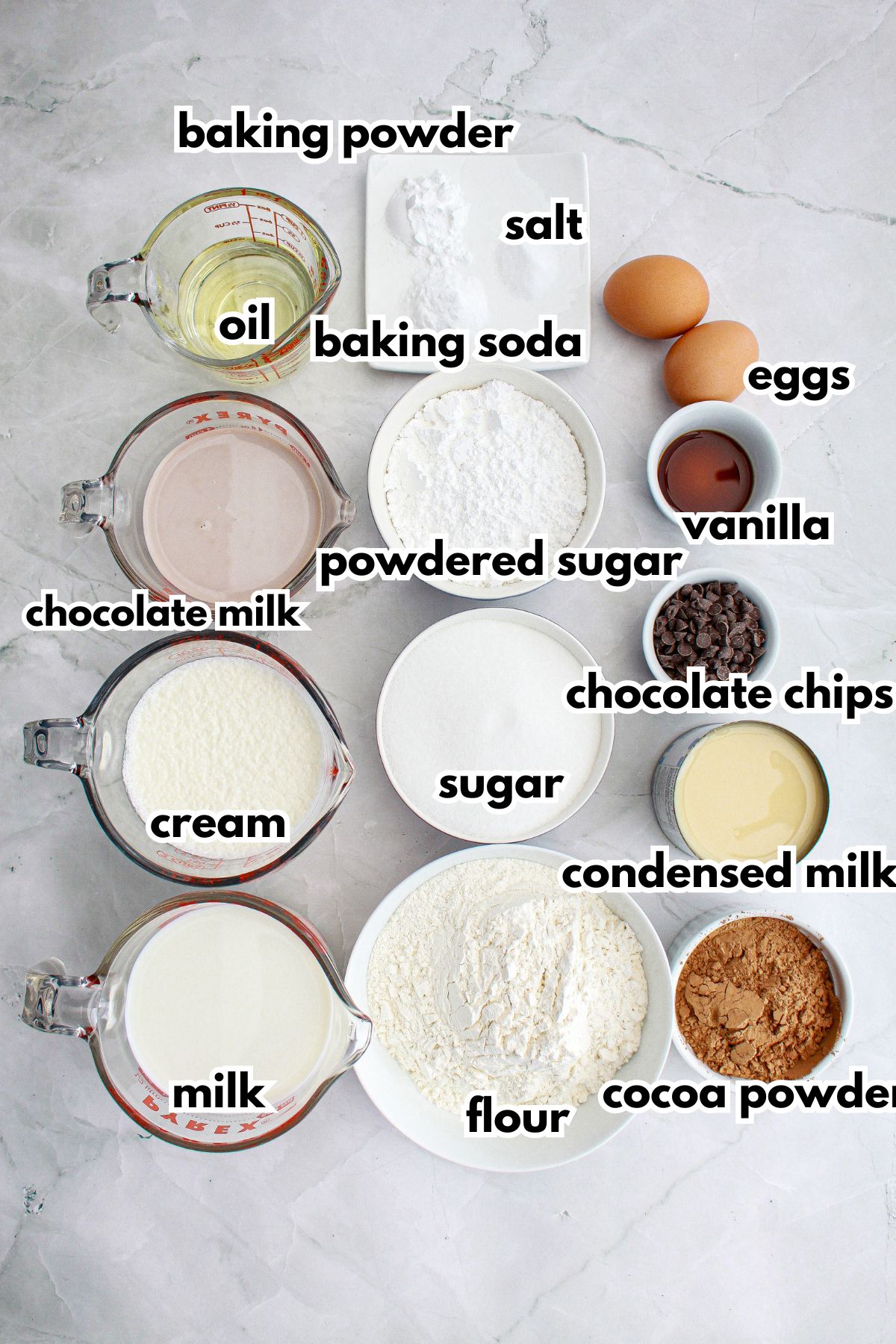 bowls of ingredients needed to make chocolate tres leches cake on a counter.