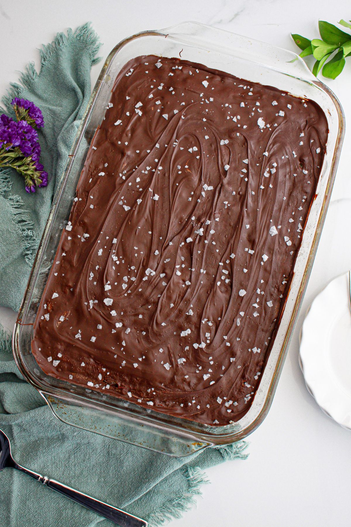 uncut salted caramel cookie dough billionaire bars in a glass baking dish.