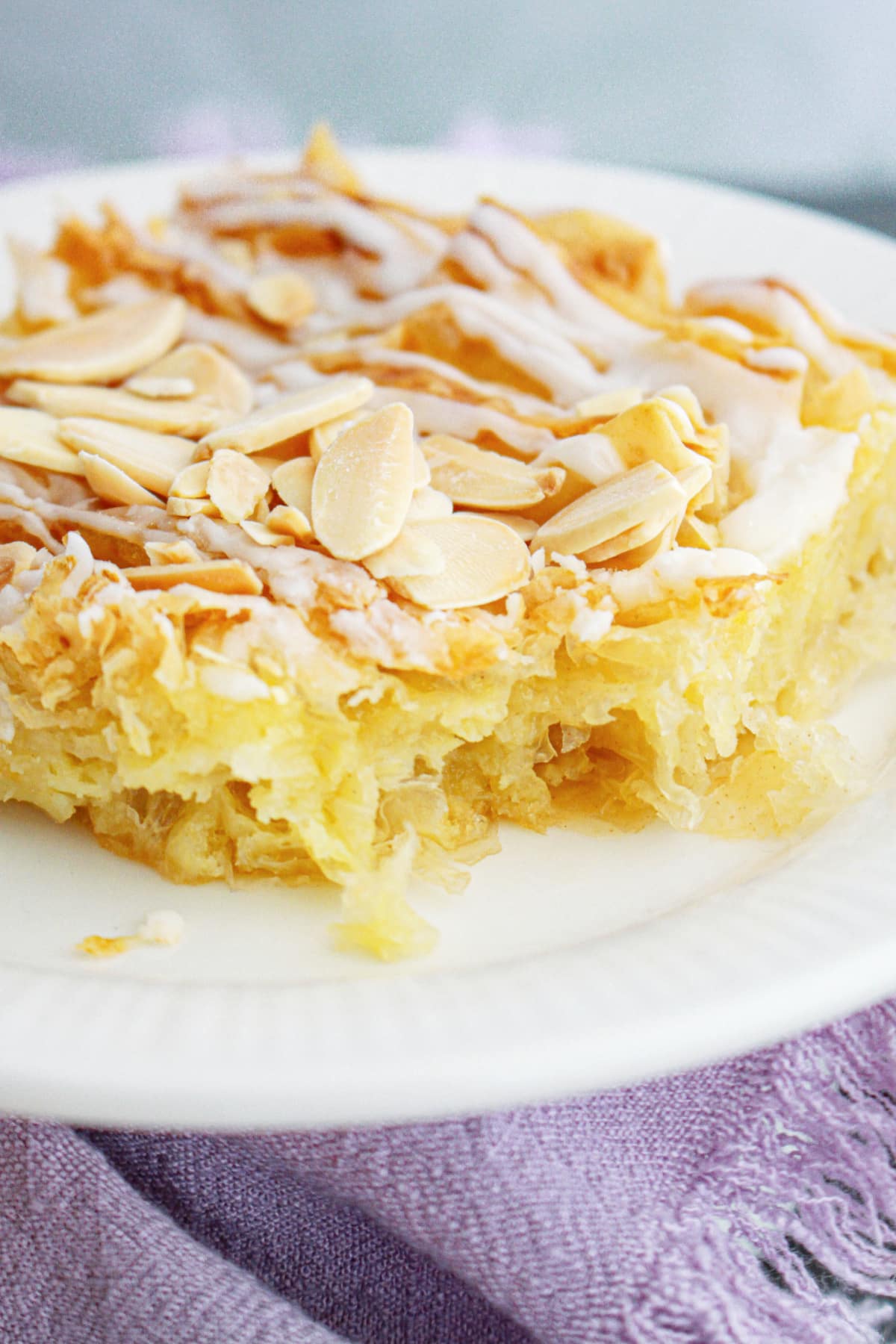 slice of crinkle cake on a plate with a bite missing.
