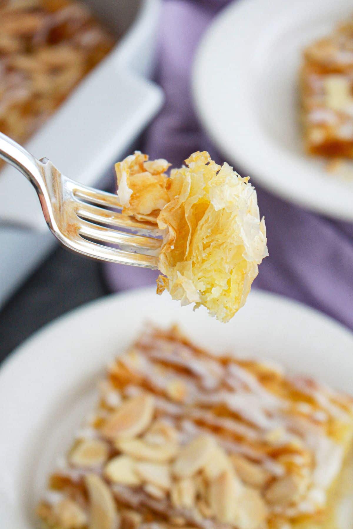 bite of crinkle cake on a fork held in the air.