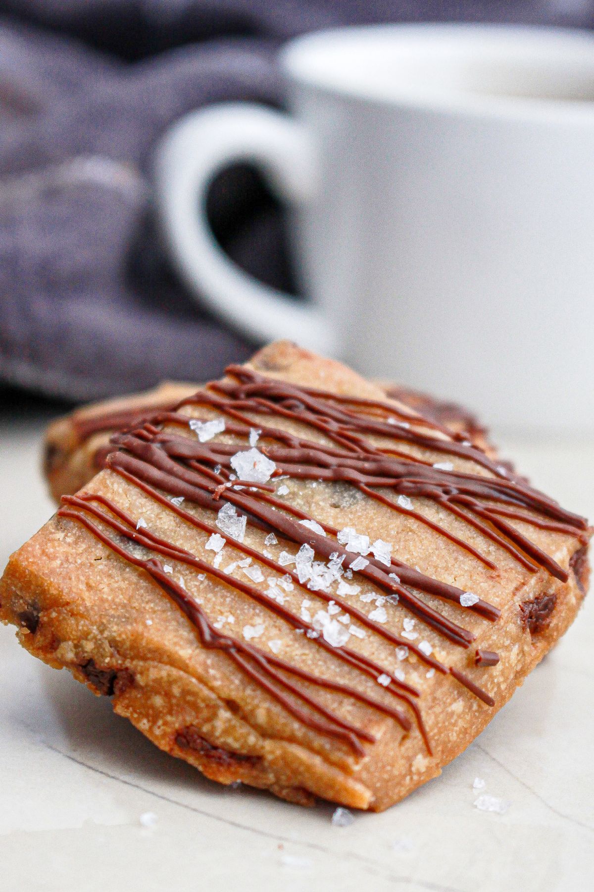 two pieces of chocolate chip espresso shortbread bars on a counter.