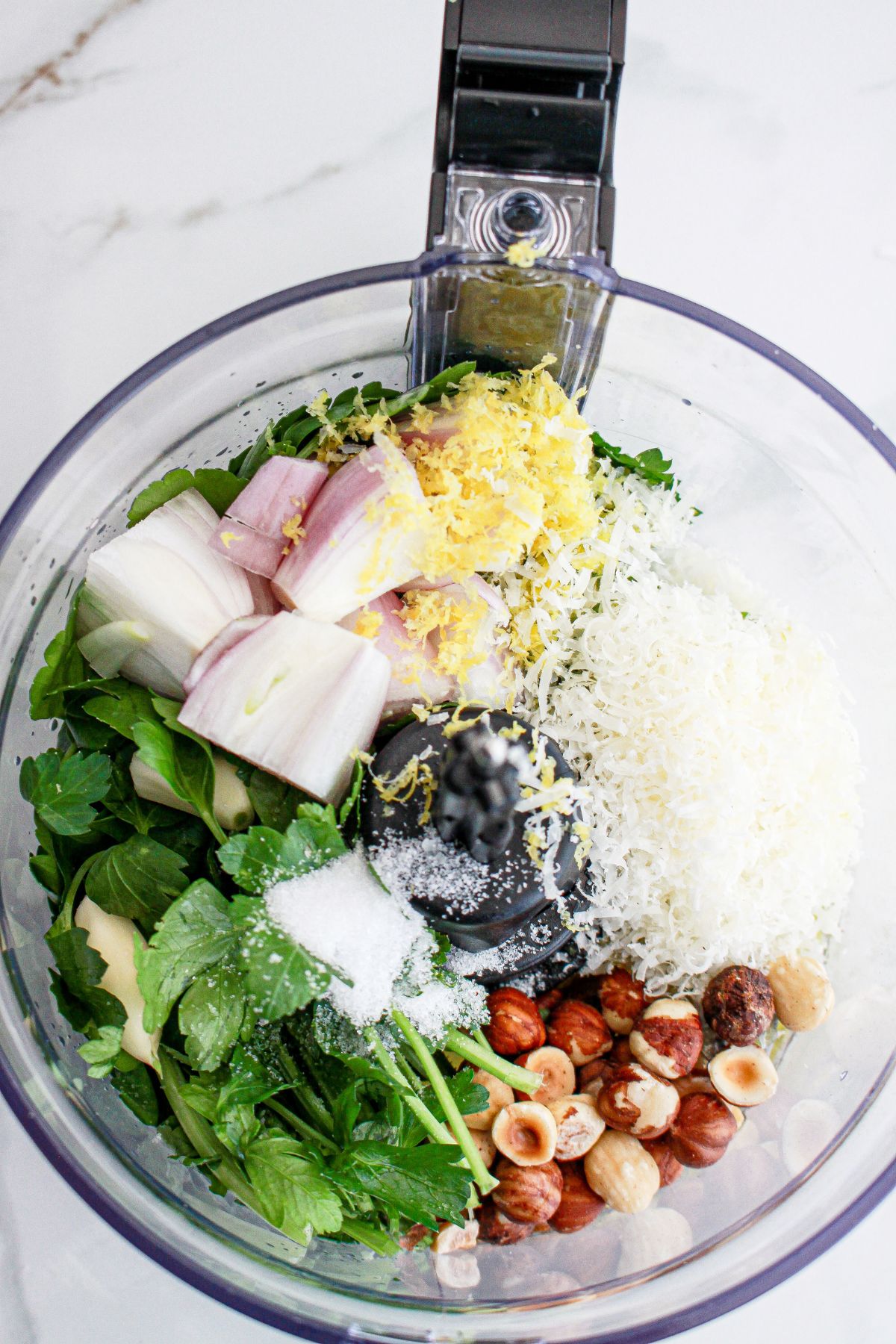 dressing ingredients being added to a food processor.