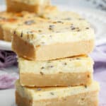 three lemon cheesecake bars on a counter.