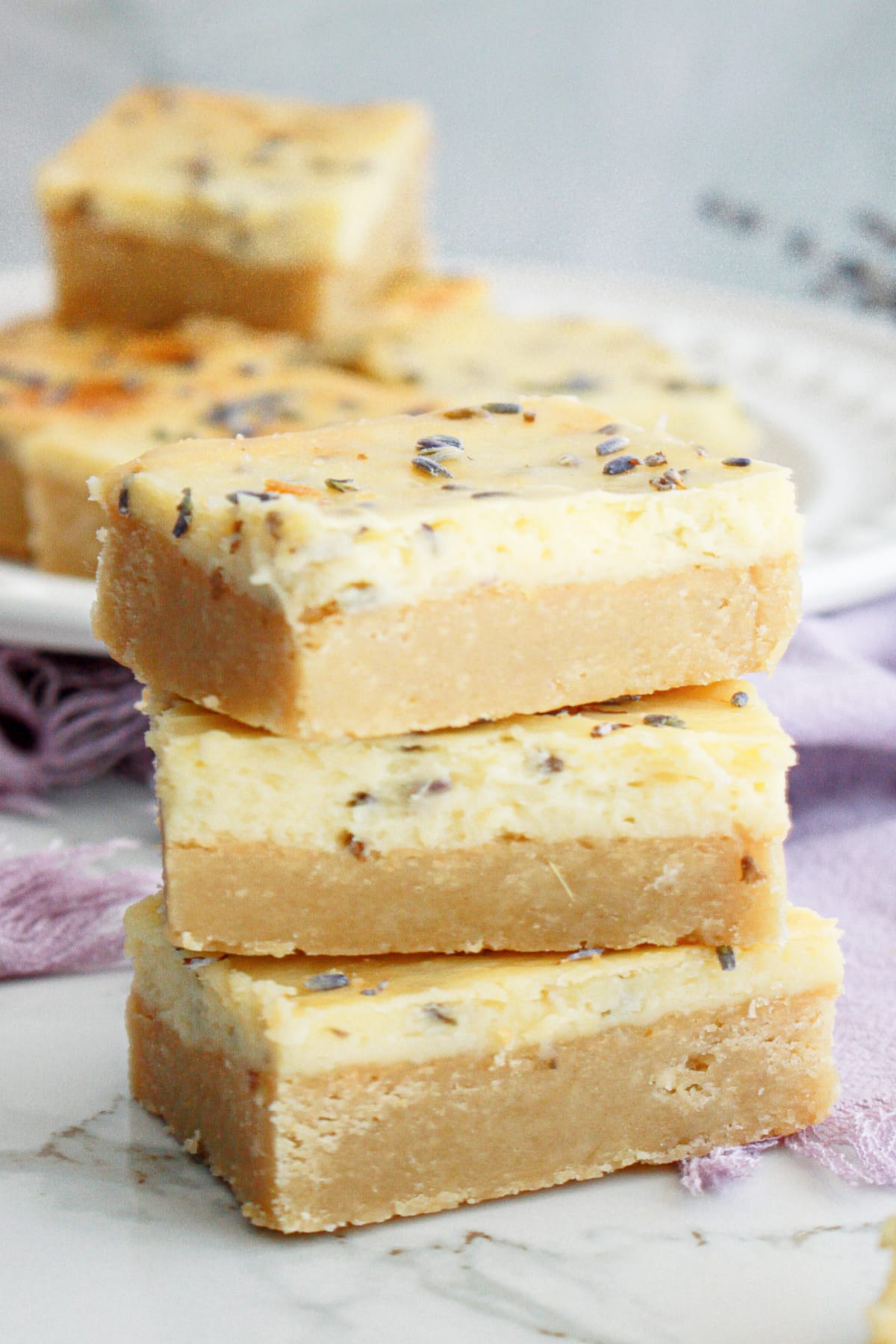 three lemon cheesecake bars on a counter.