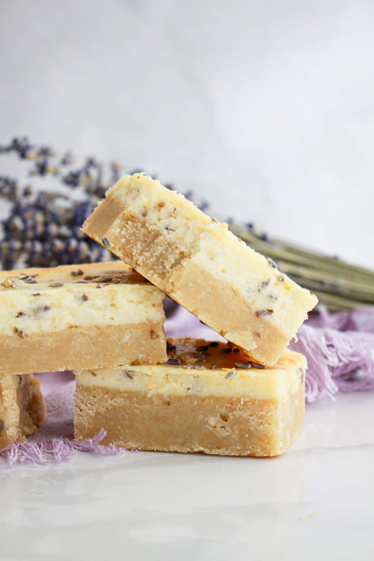 three lemon cheesecake bars on a counter.
