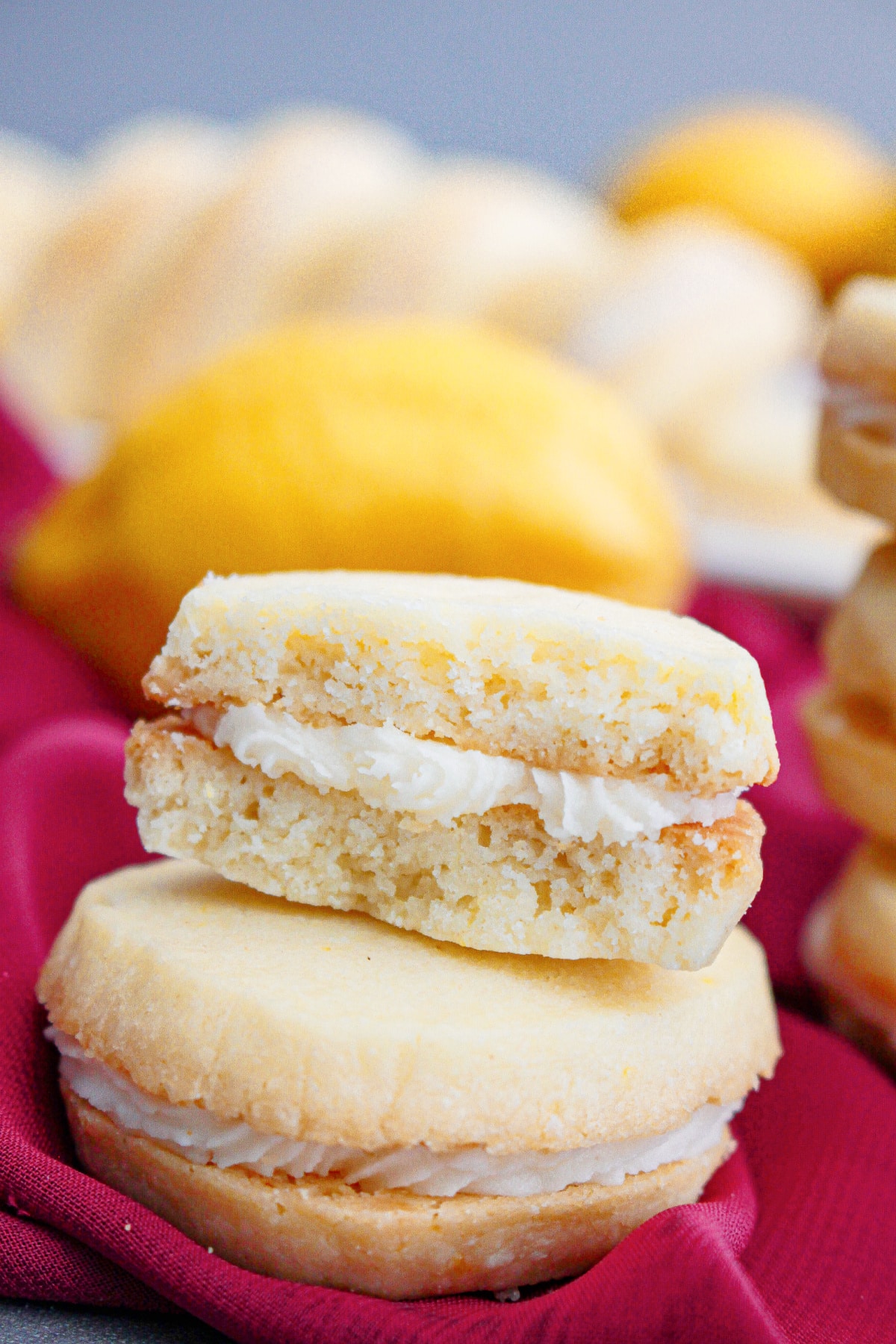 two lemon meltaway cookies stacked on top of each other.