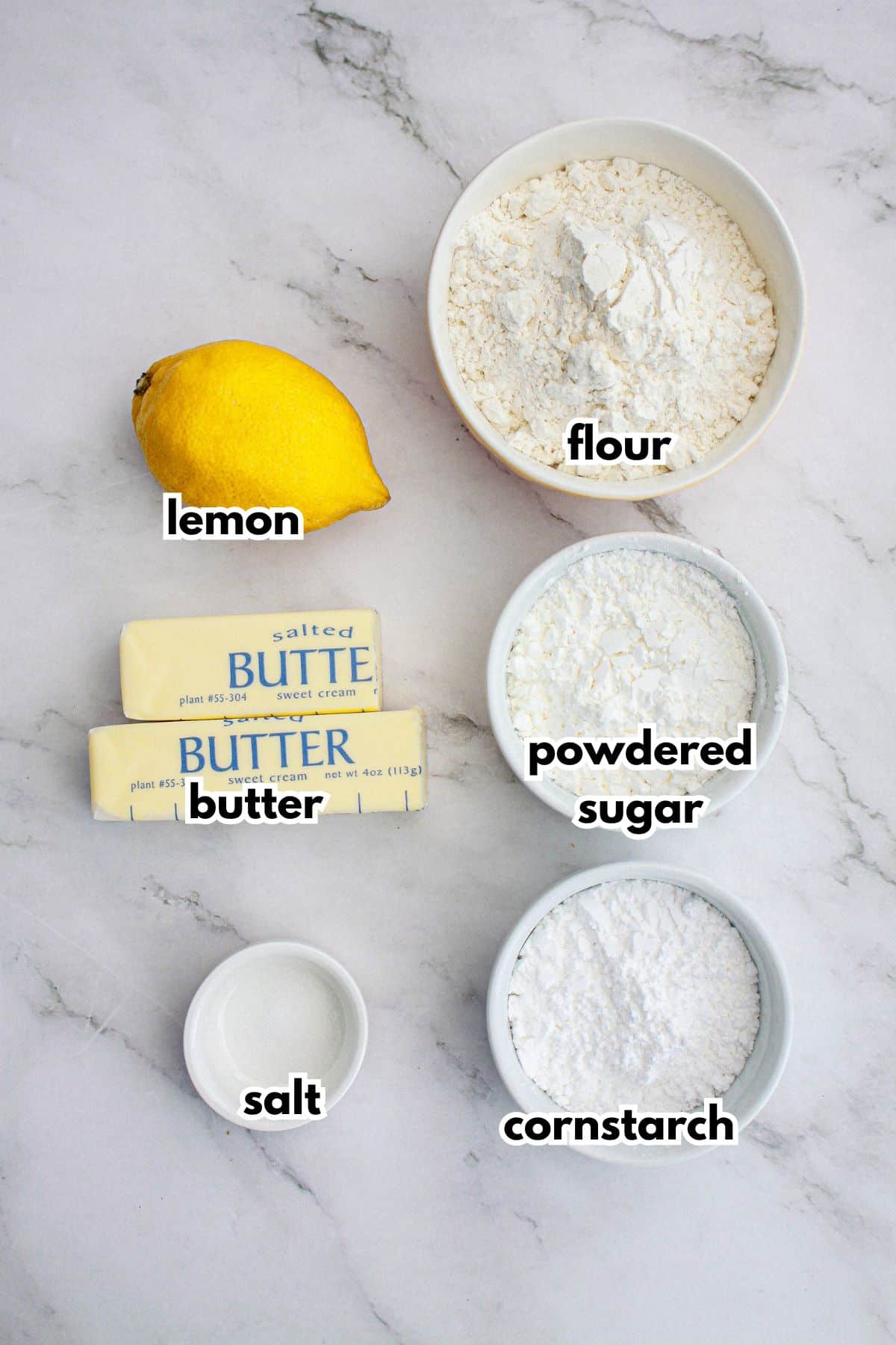 bowls of lemon, flour, butter, powdered sugar, salt, and cornstarch.