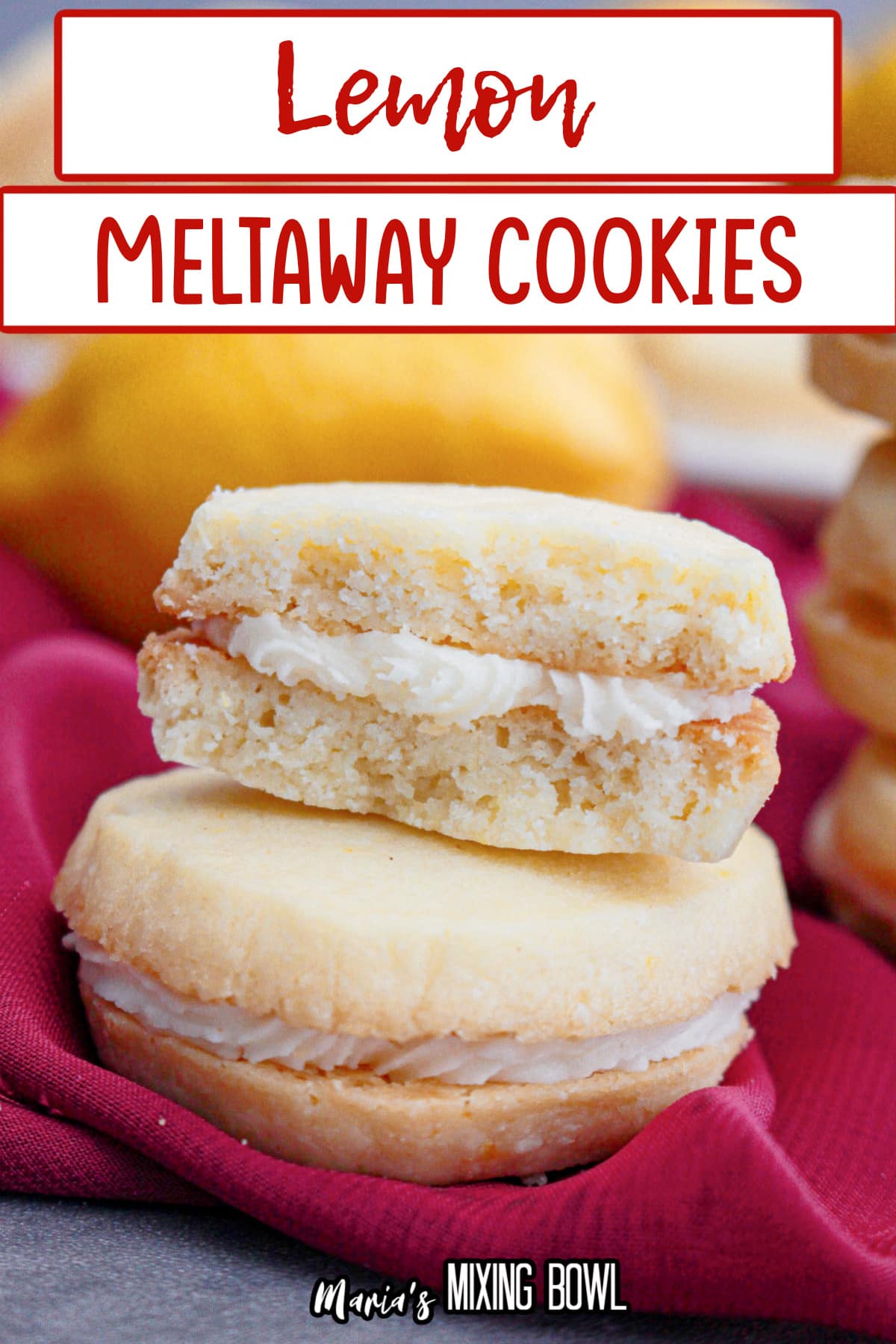 two lemon meltaway cookies stacked on top of each other.