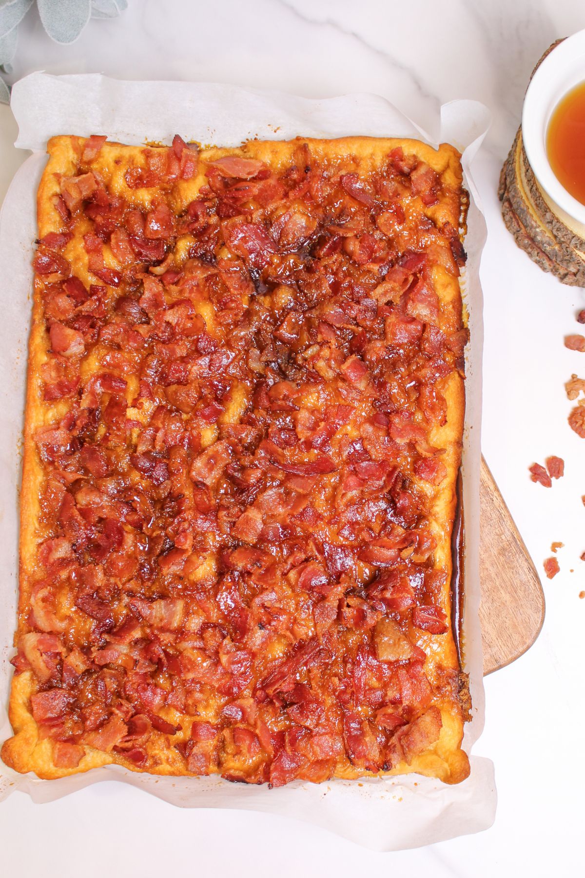 uncut maple bacon caramel crack on a piece of parchment paper.