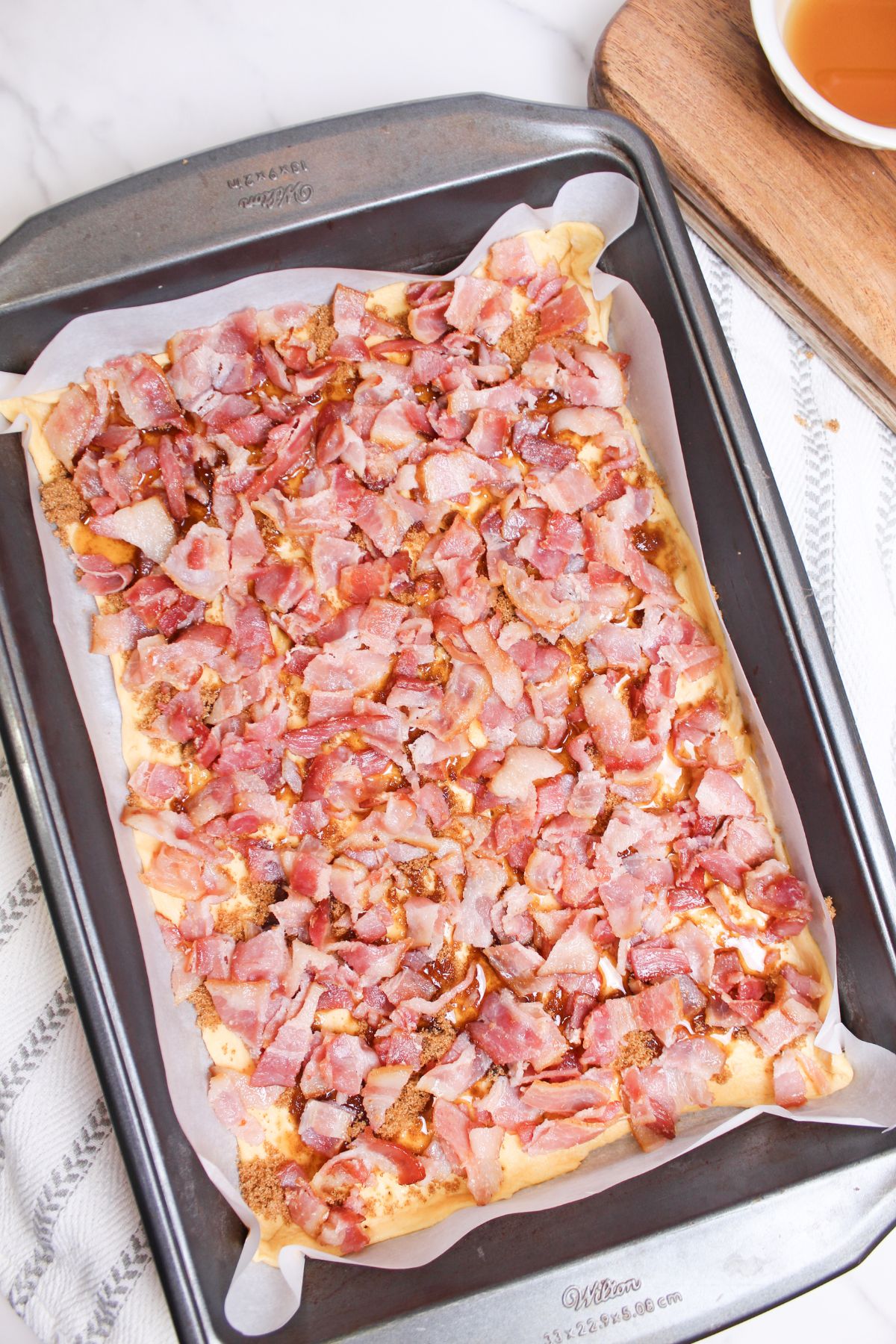 maple bacon crack on a baking dish ready for the oven.