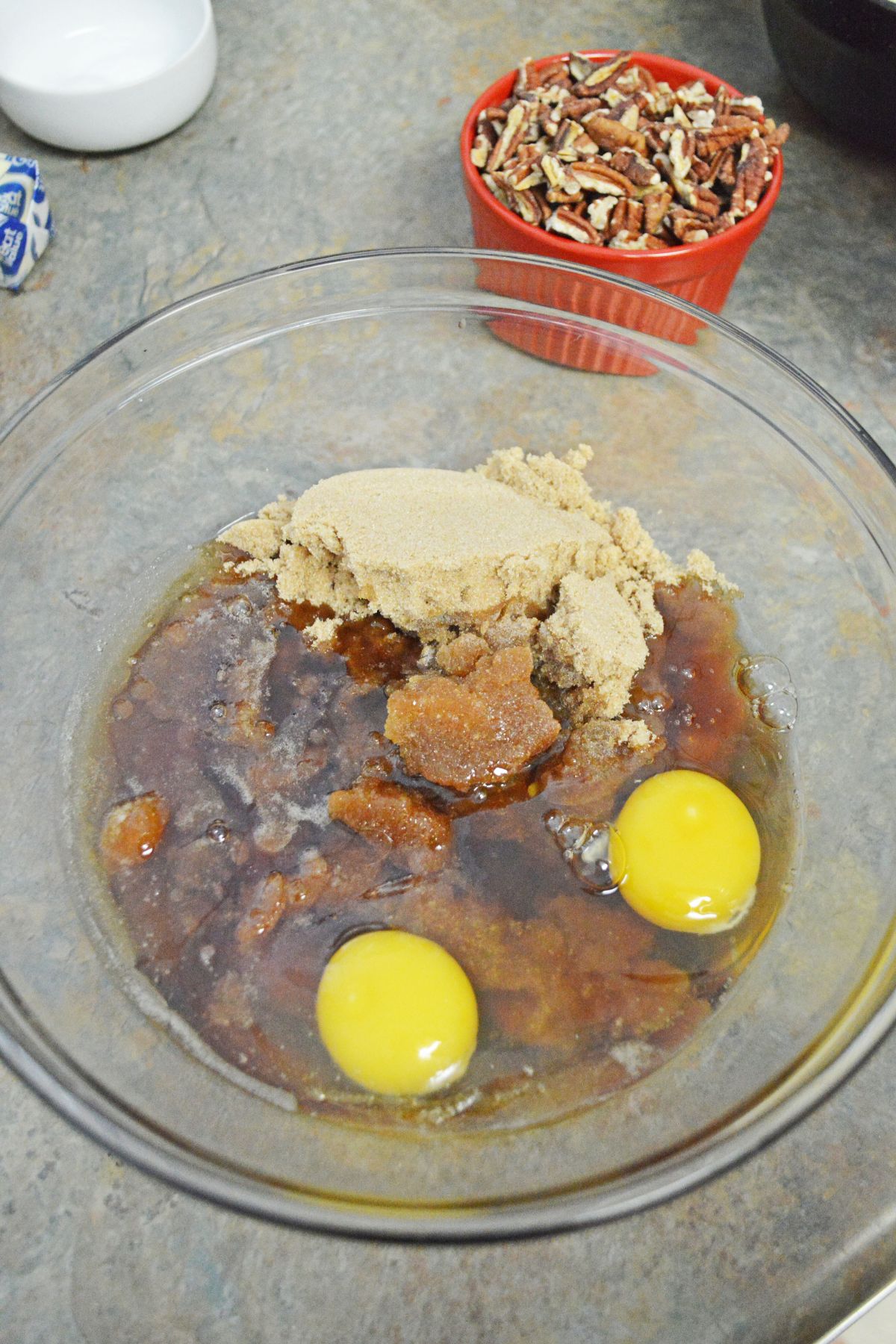 brown sugar, and eggs being mixed in a large bowl.