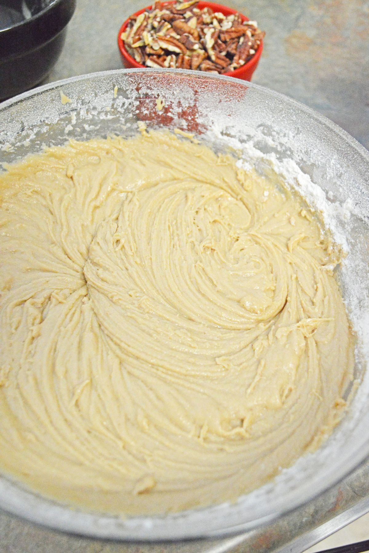 dough being mixed in a large mixing bowl.