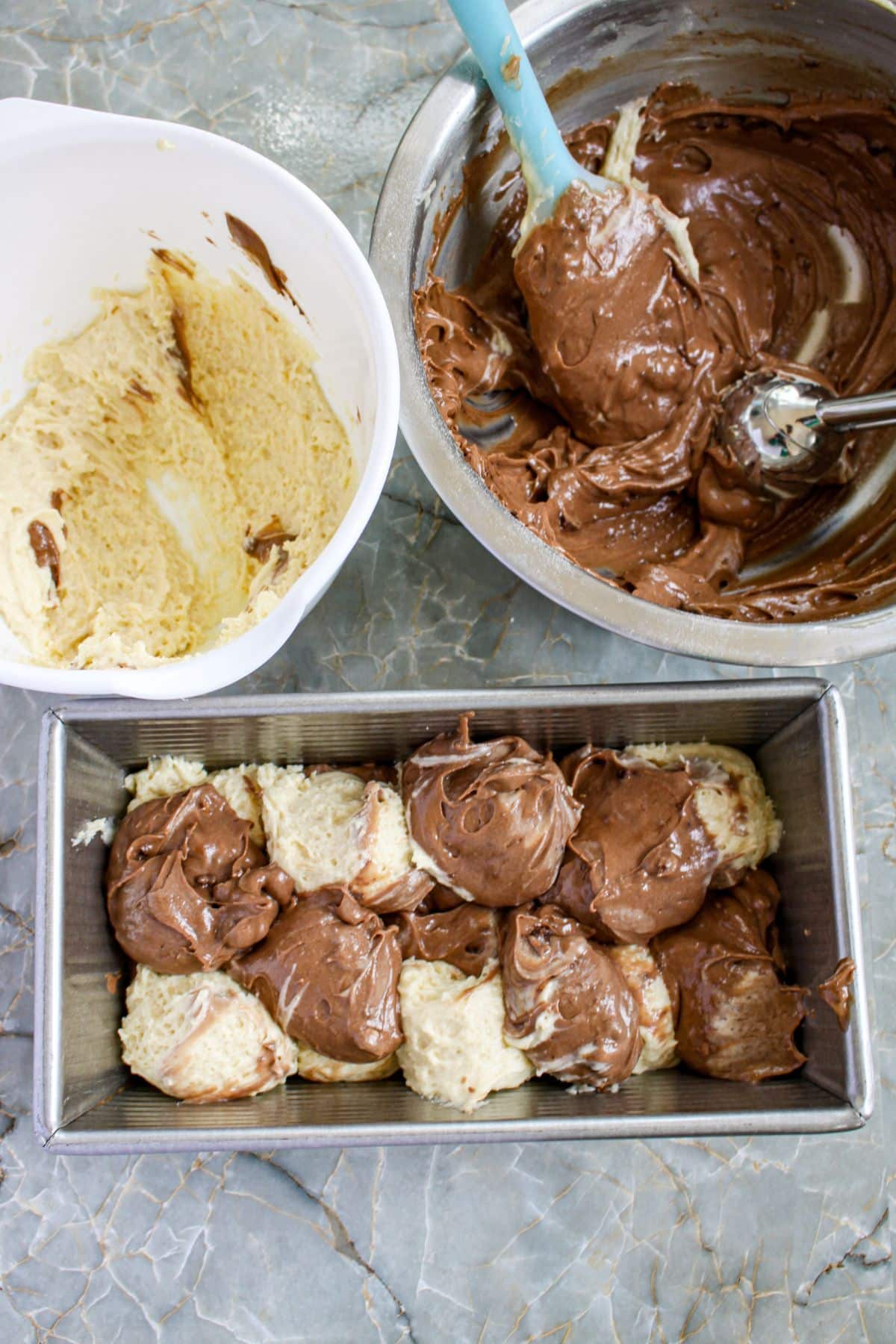 batter being added to a loaf pan.