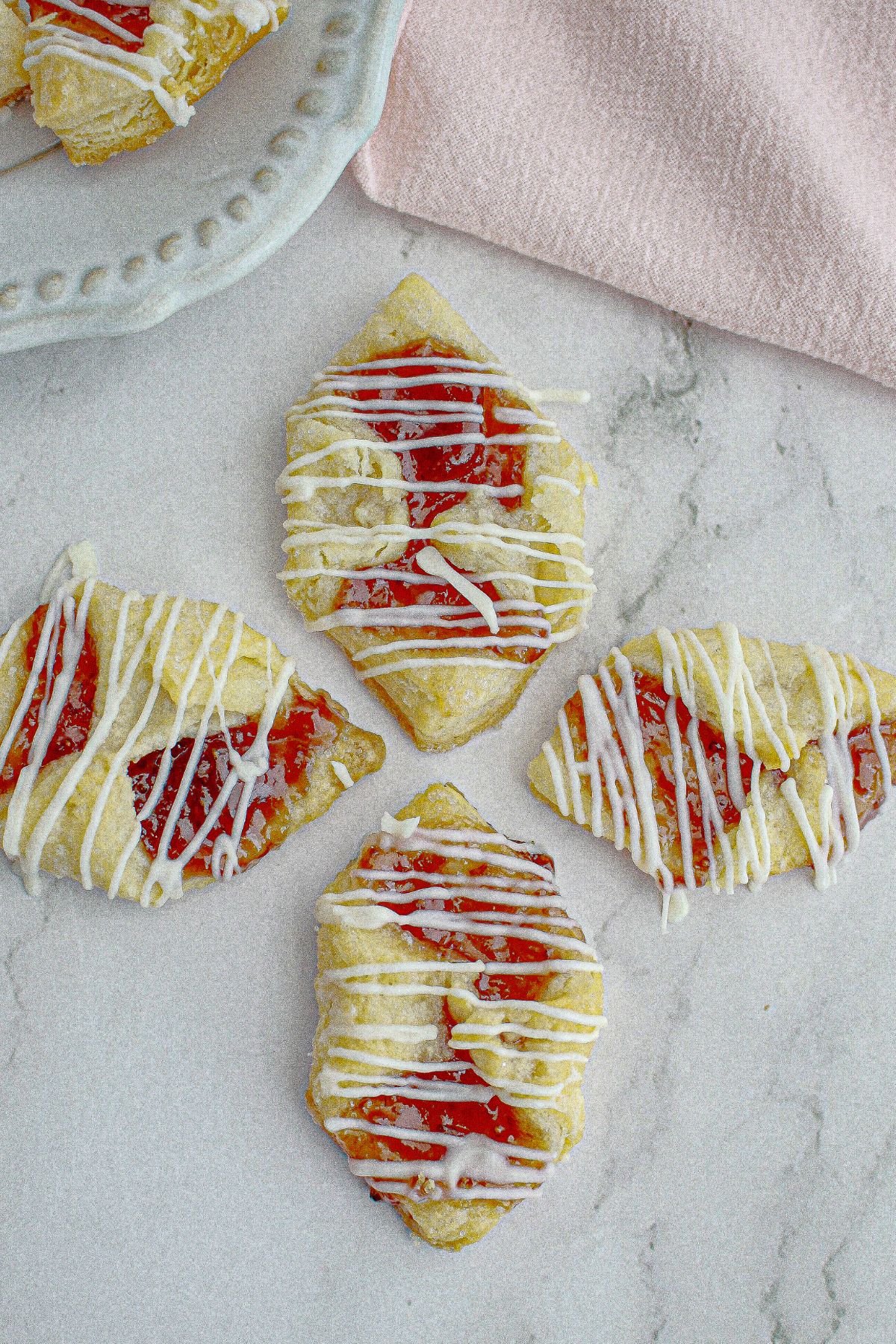 four polish cookies on a marble counter.