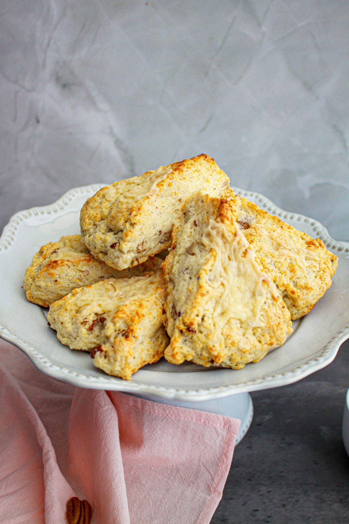 white cheddar scones stacked on a plate.