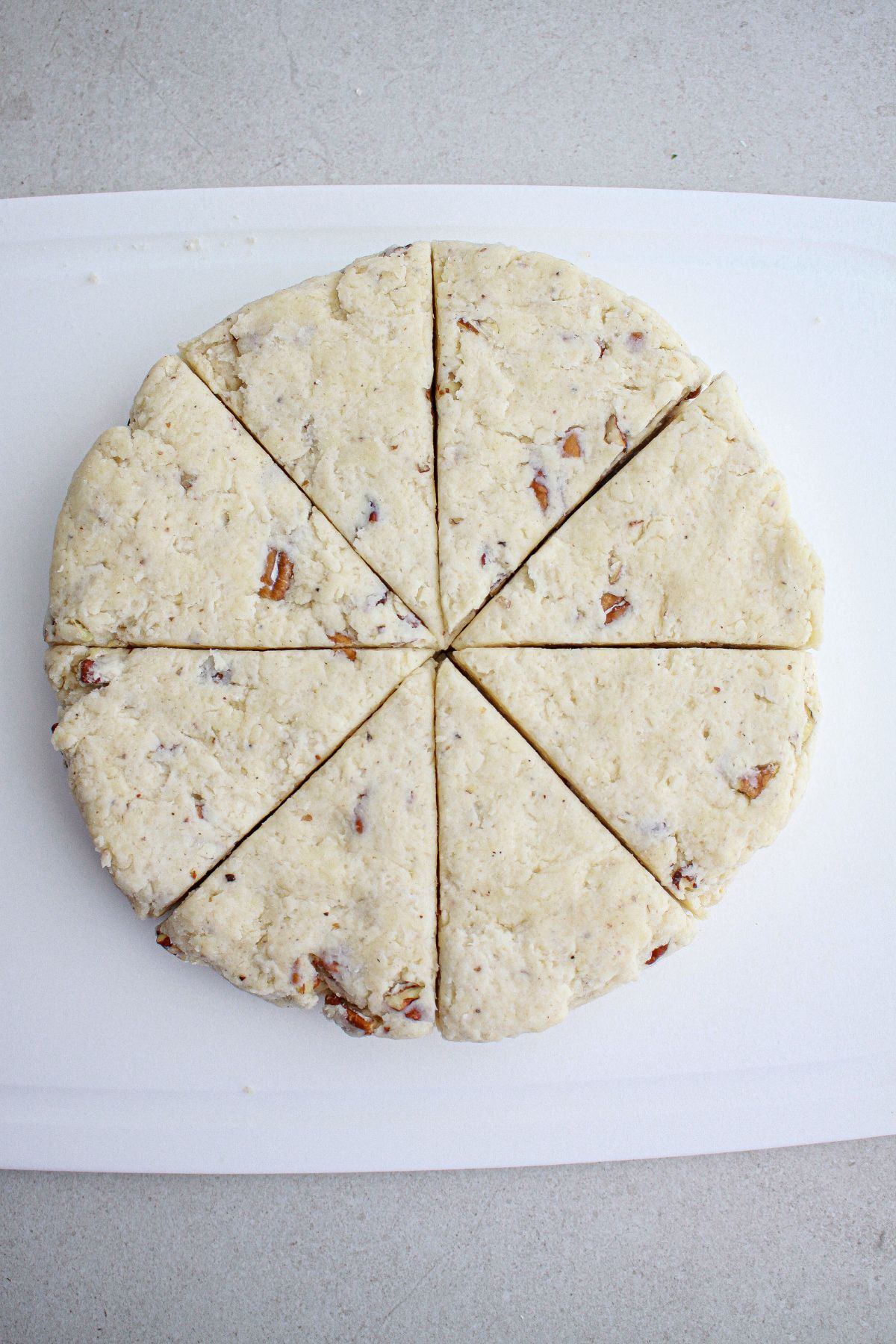 dough on parchment paper being cut into triangles.