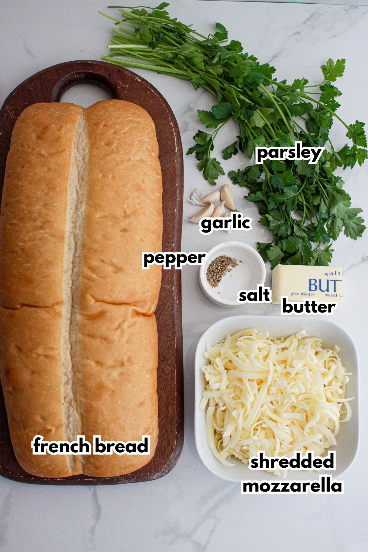 loaf of bread, shredded mozzarella, parsley, garlic, pepper, salt, and butter.