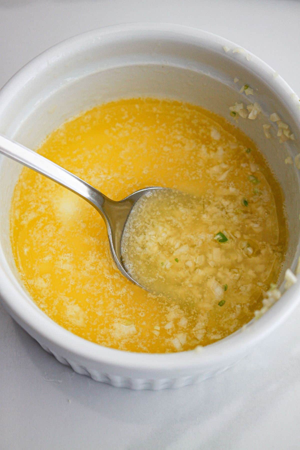 garlic butter being mixed in a small bowl.