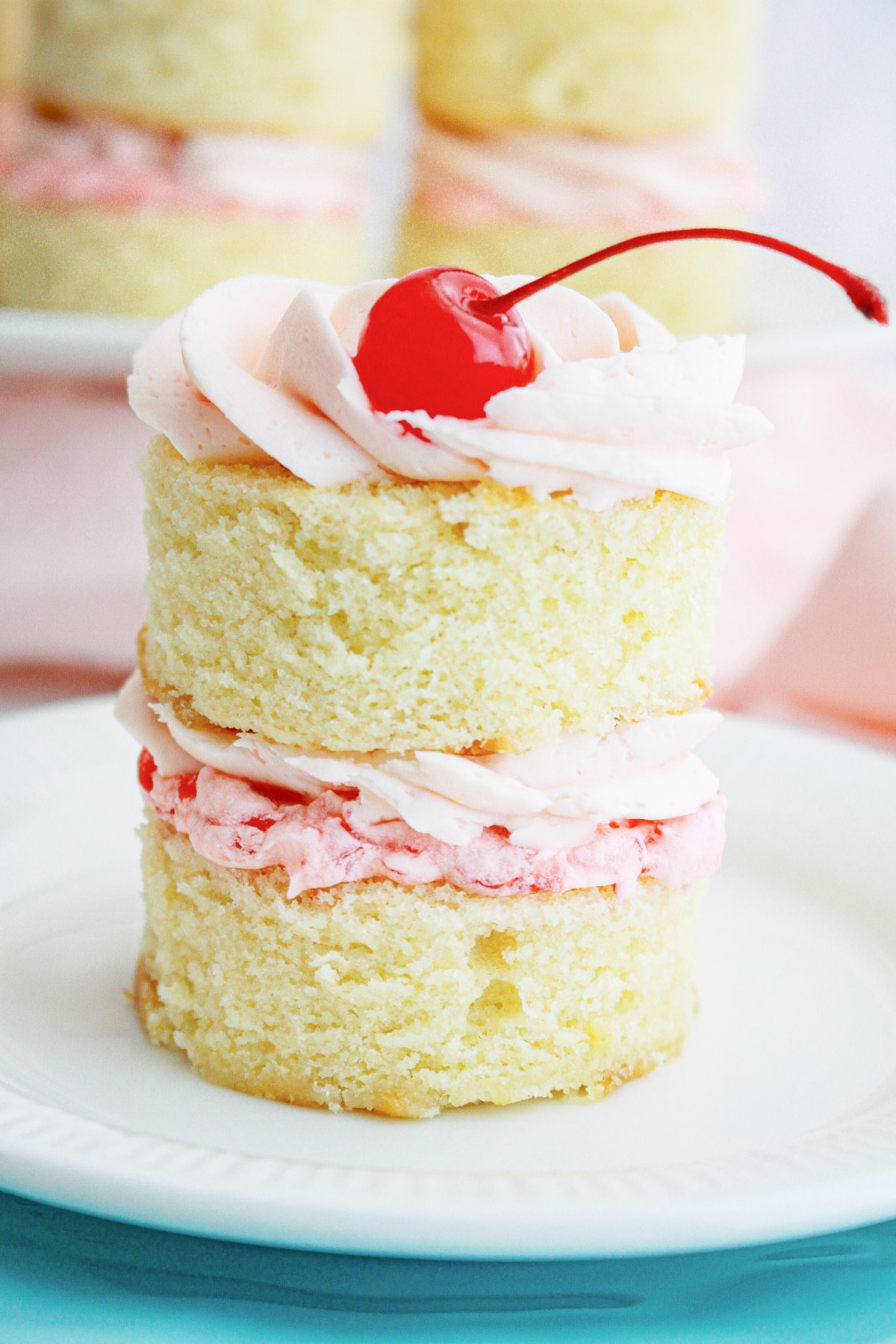 mini cherry almond cake on a small plate.