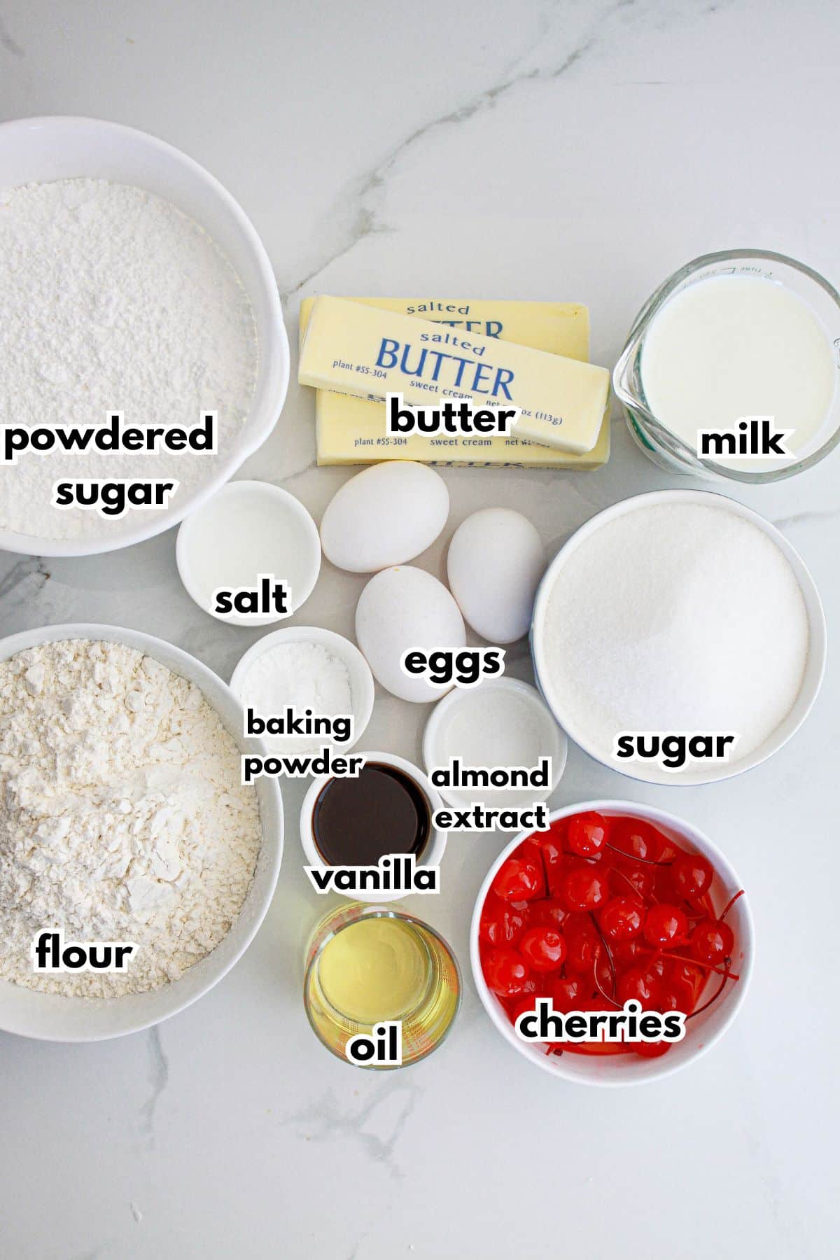 bowls of ingredients needed to make cherry almond cake on a counter.