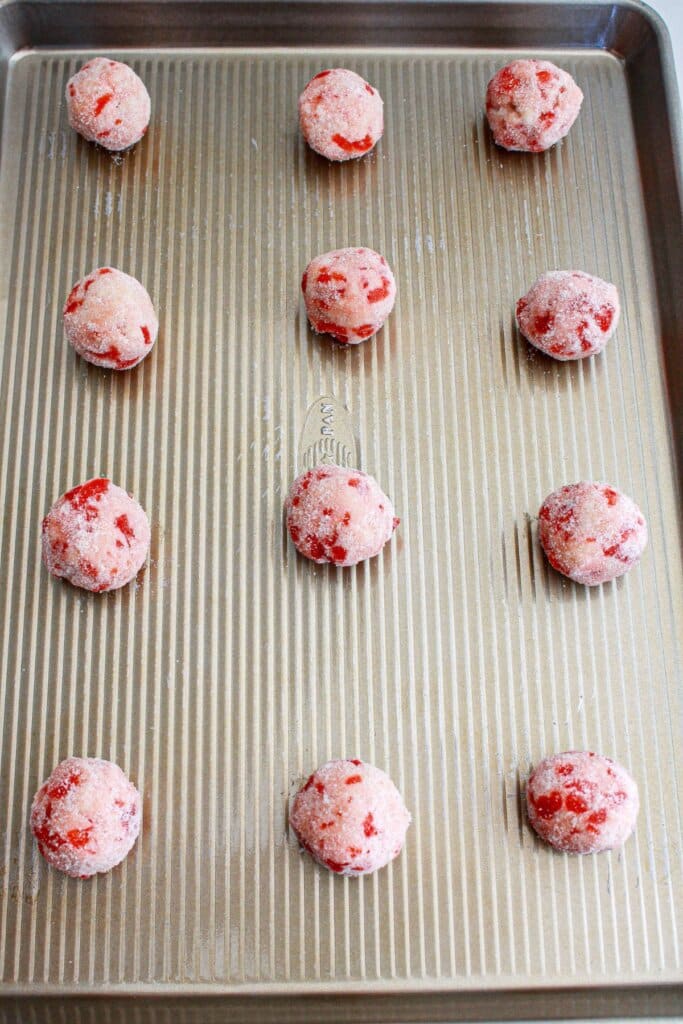 cookie dough balls on a cookie sheet ready for the oven.