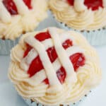 three cherry pie cupcakes on a white plate.