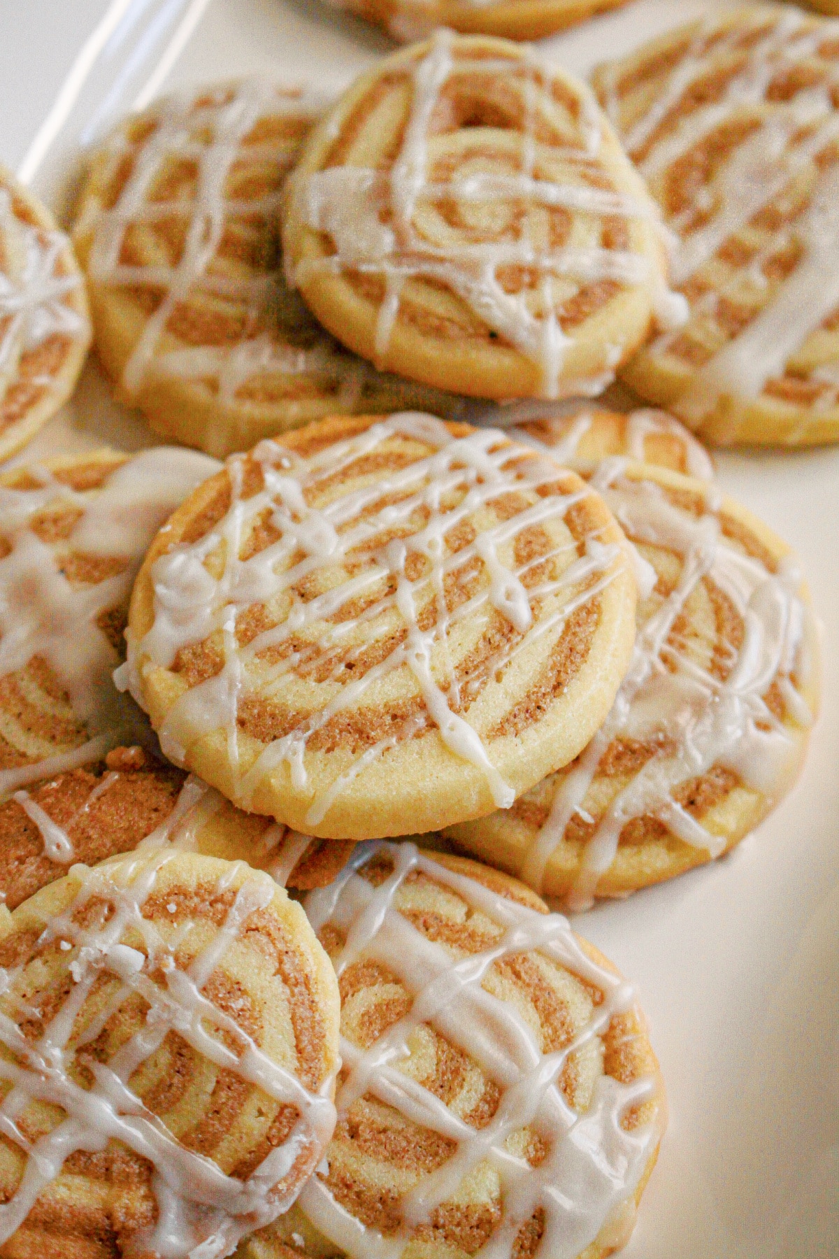 cinnamon bun cookies stacked on a plate