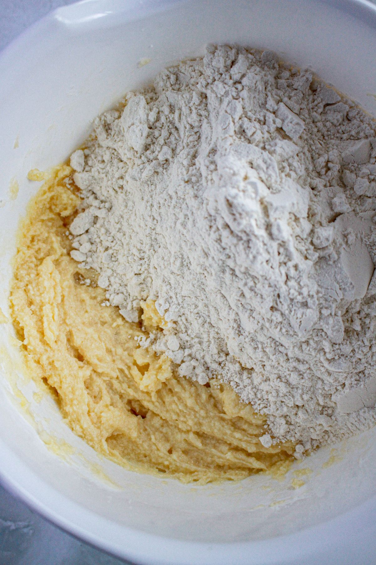 cookie dough being mixed in a large mixing bowl.