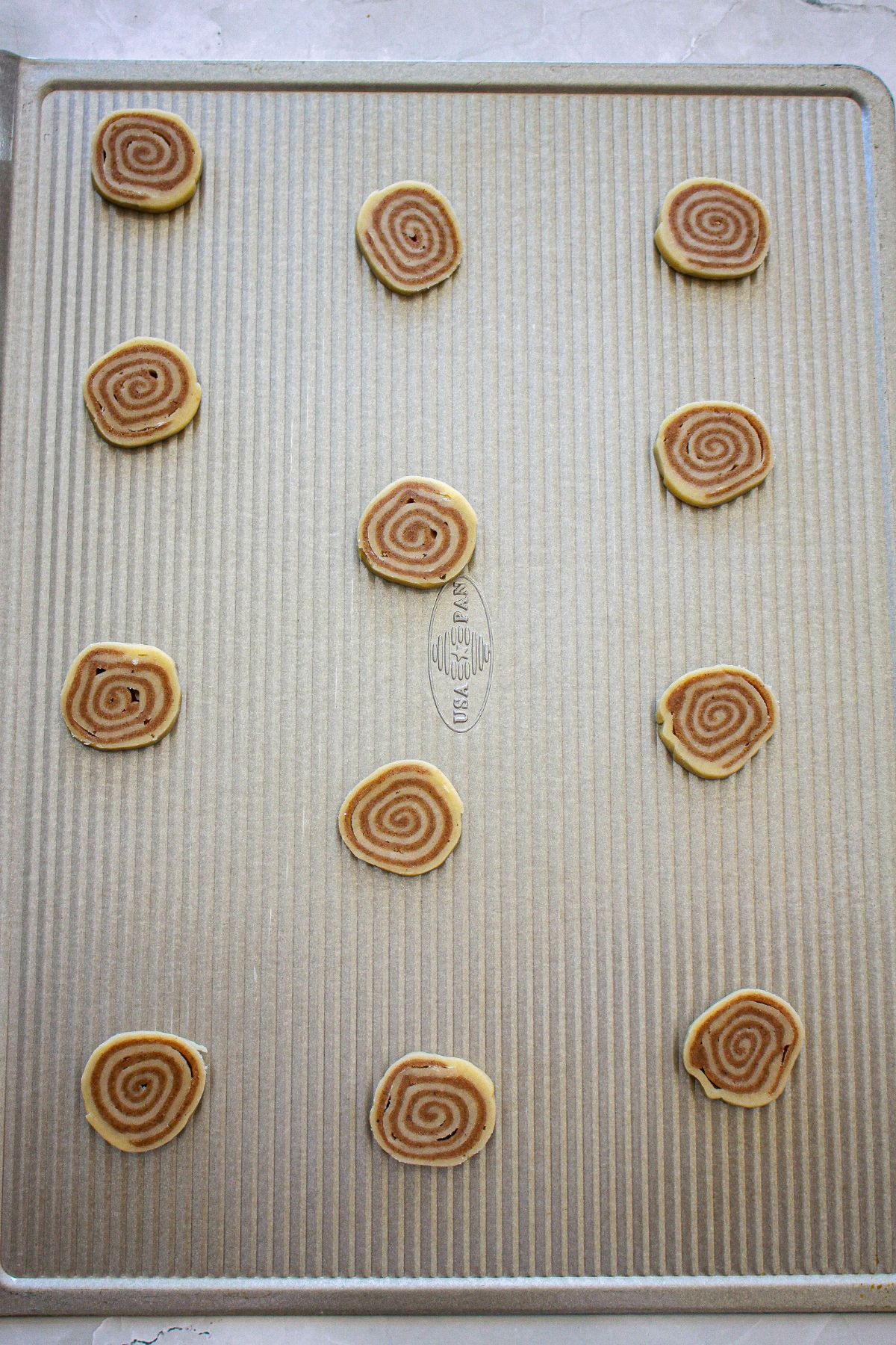 cookie dough rounds on a baking sheet.