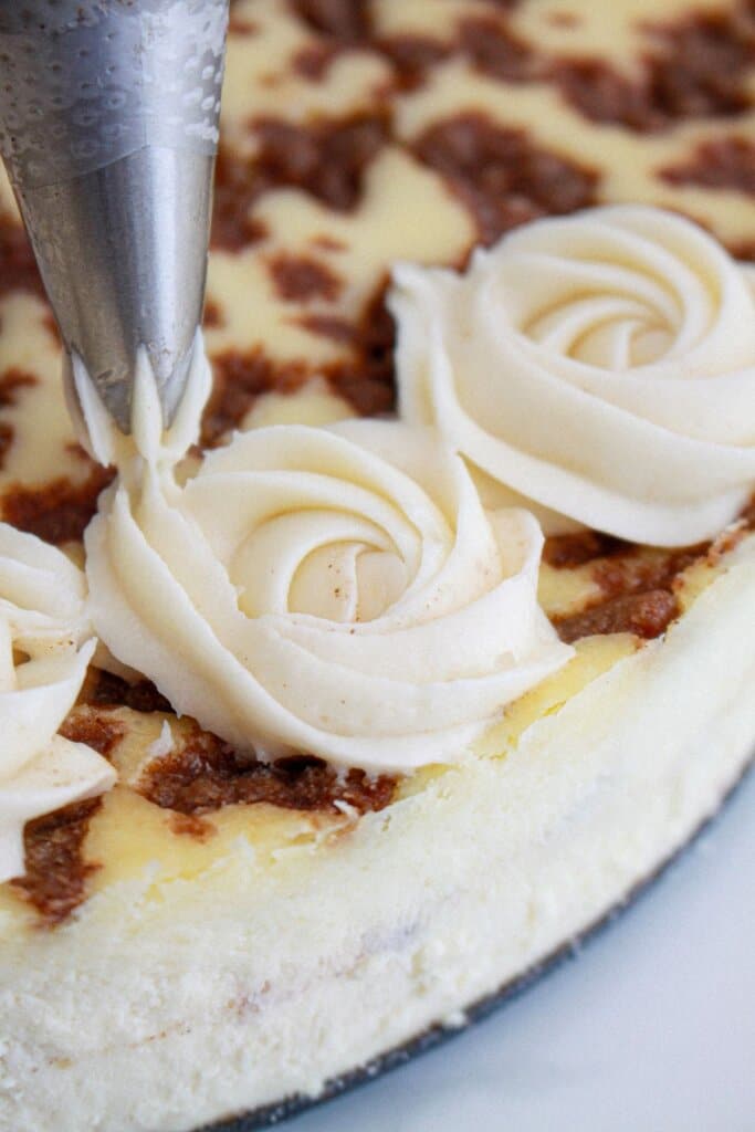 frosting being piped on top of a dessert.