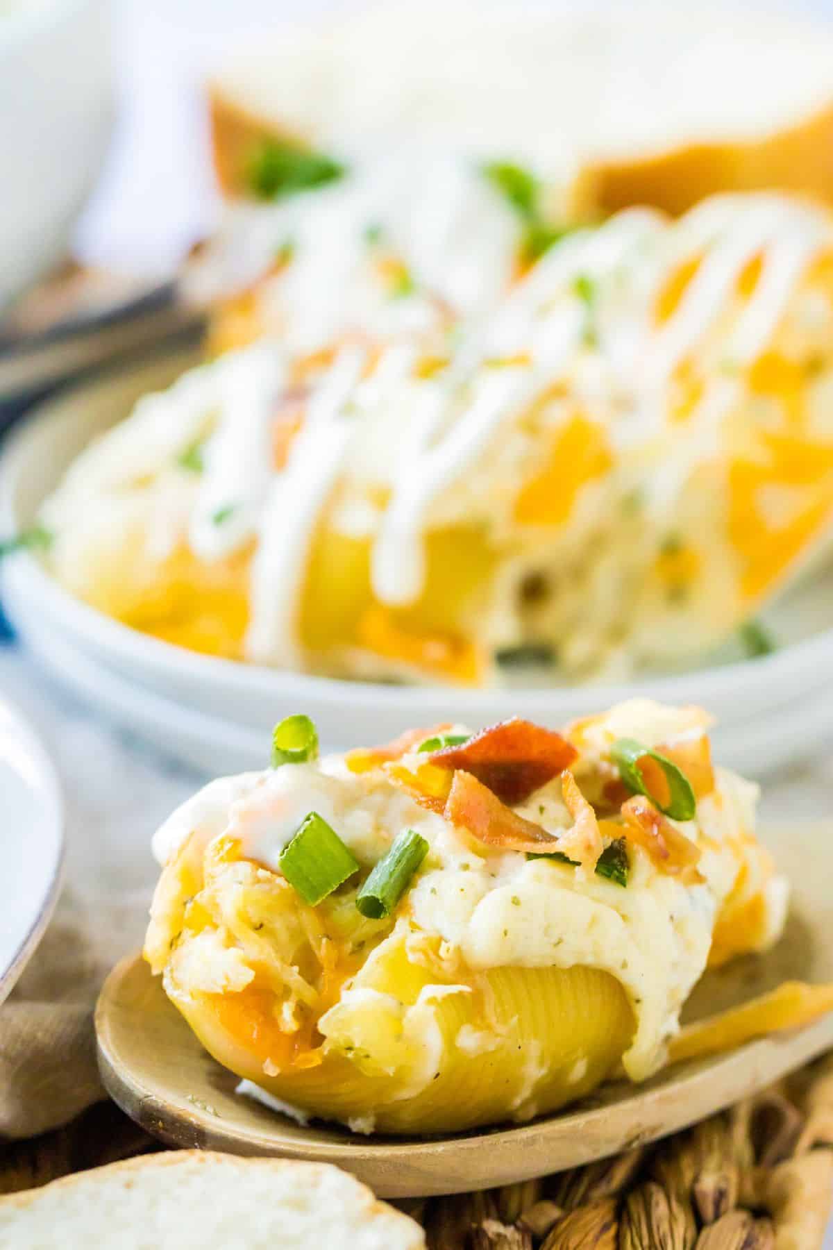 crack chicken stuffed shells on a wooden spoon.