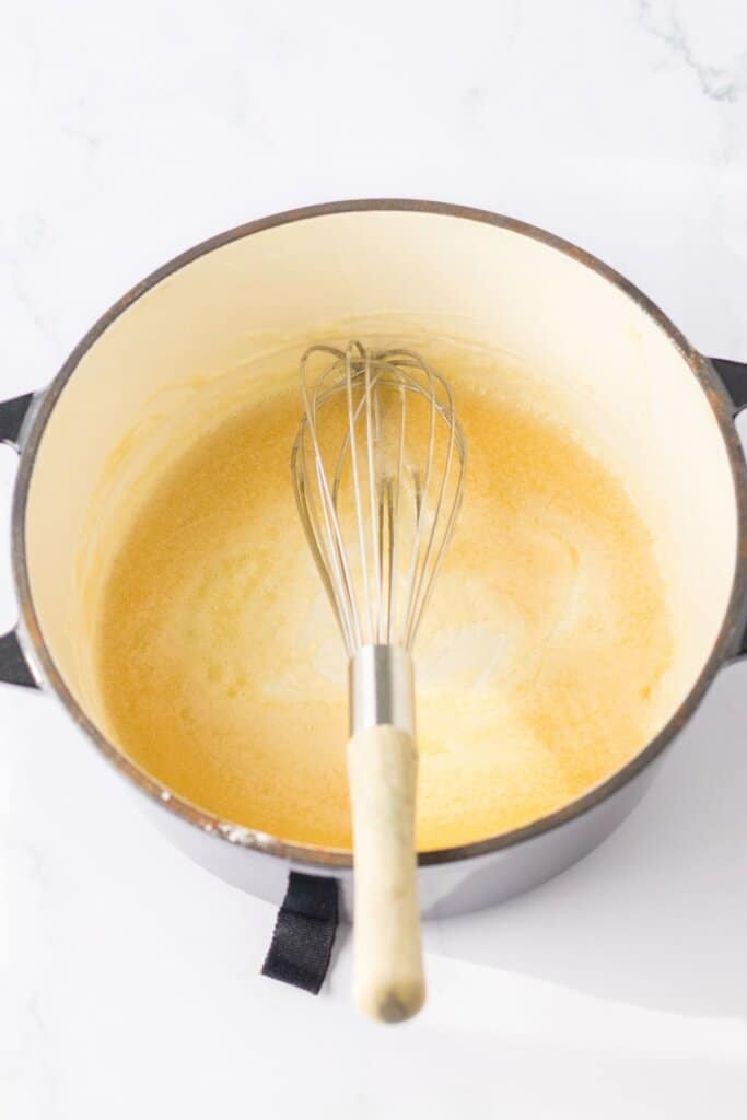 butter and flour being cooked in a dutch oven.