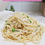 plate full of cream cheese pasta.