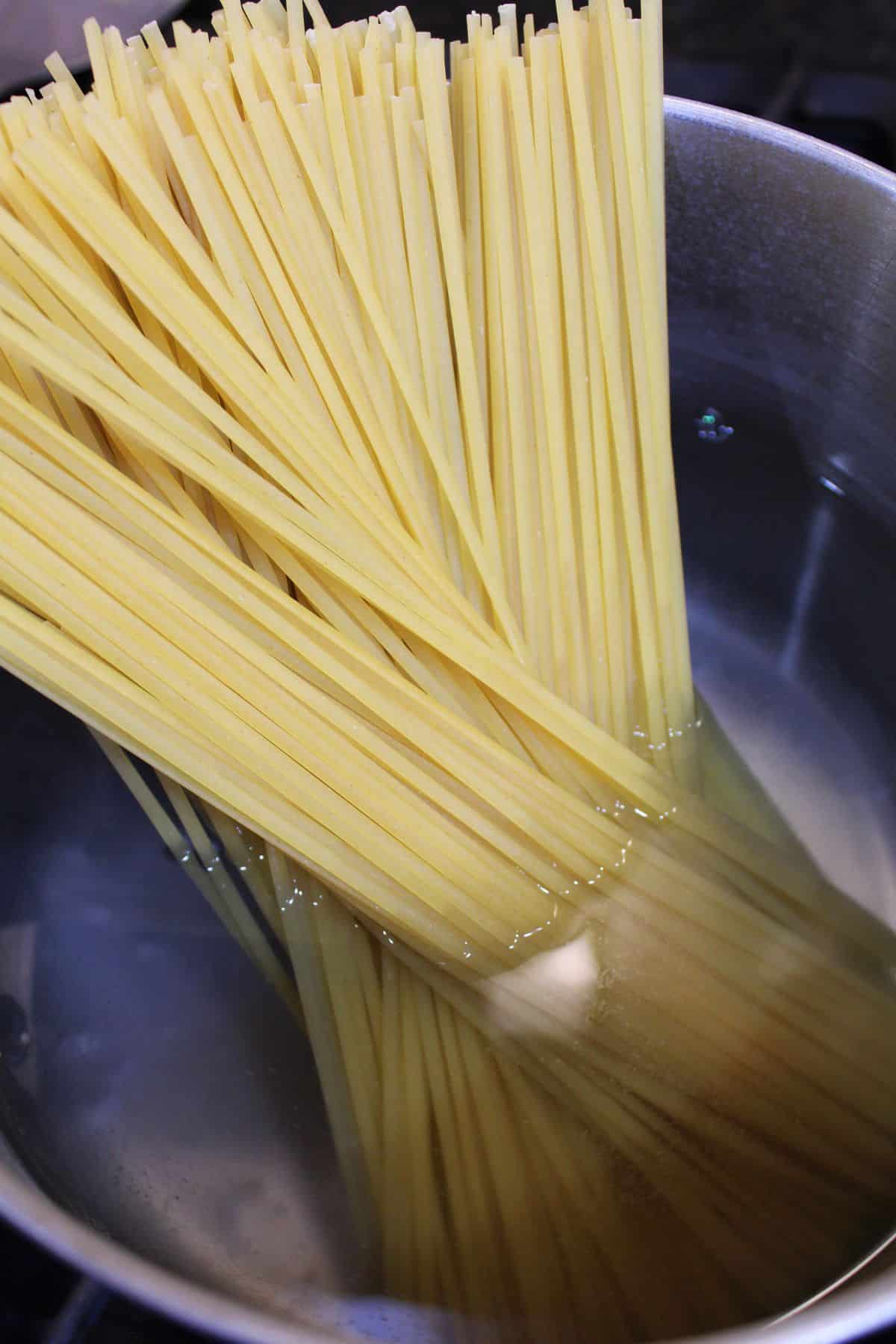 pasta being cooked in a saucepan.