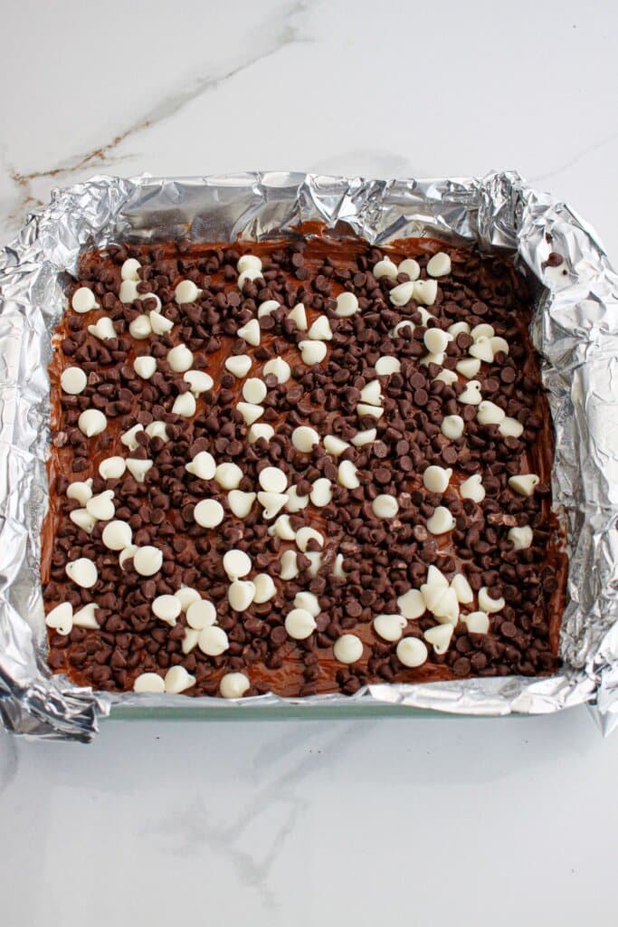 finished death by chocolate cheesecake in a foil lined baking dish.