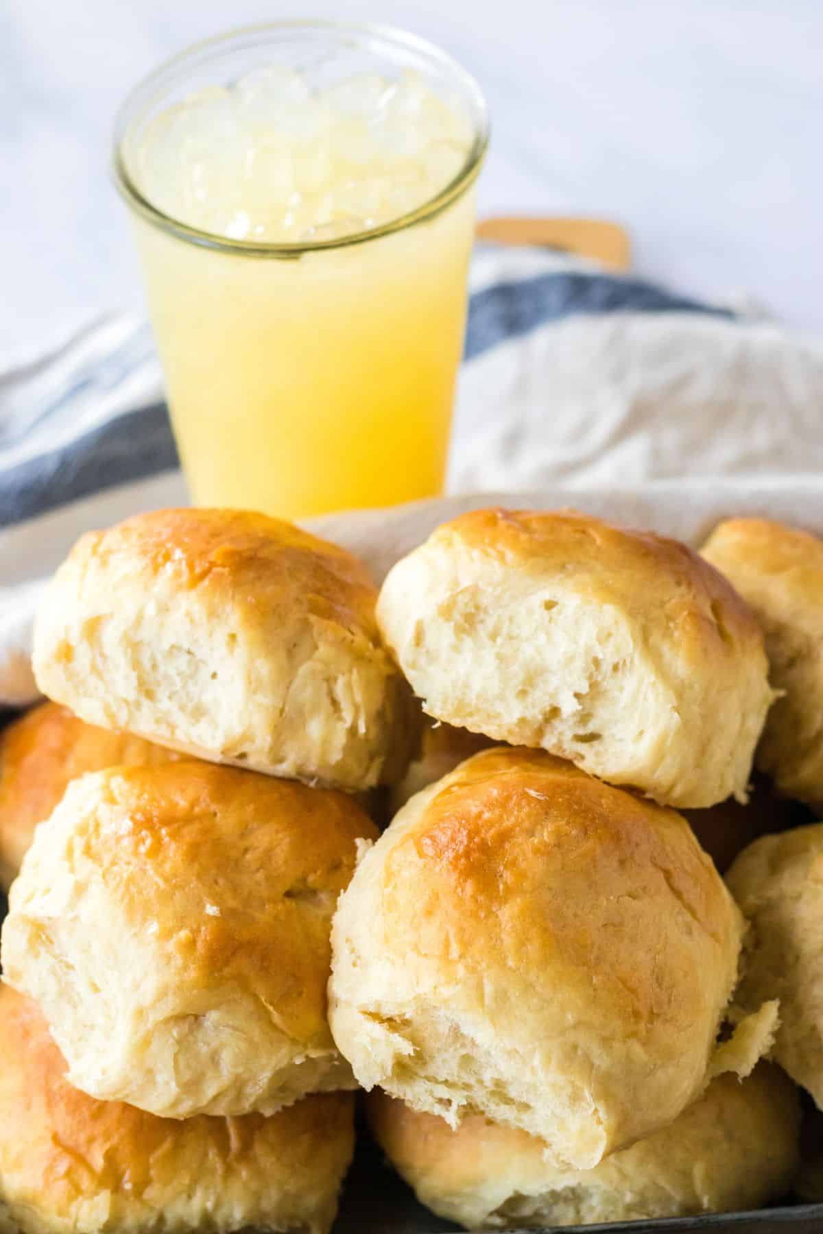 homemade hawaiian rolls stacked in a serving basket.