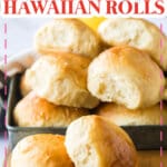two homemade hawaiian rolls on a wooden cutting board.