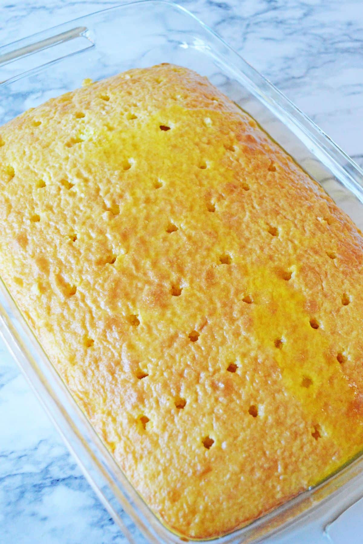 holes being poked into a baked cake.
