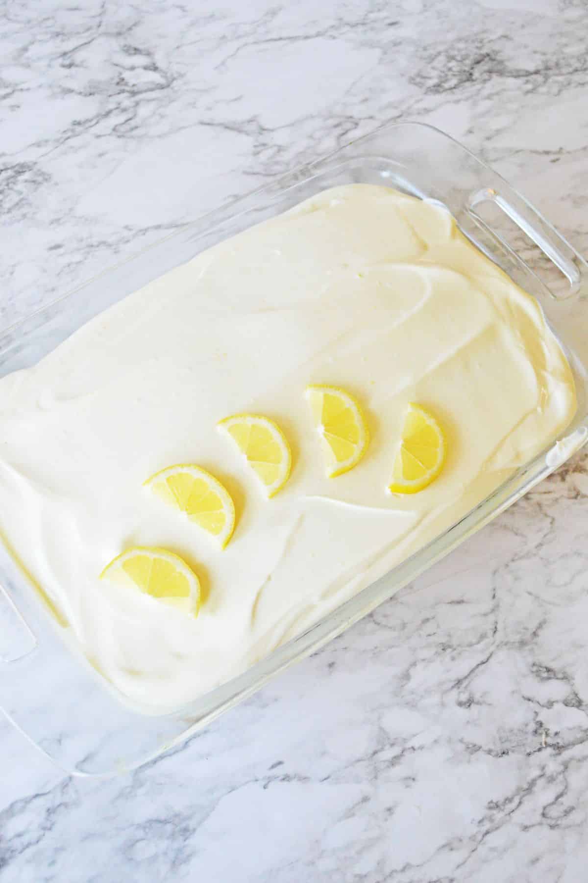 frosted cake in a glass baking dish.
